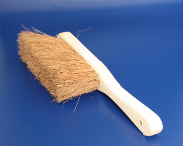 Hand brush with coconut placement